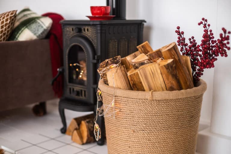 poêle à bois en fonte avec bûches stockées à côté pour un usage pratique et une ambiance chaleureuse